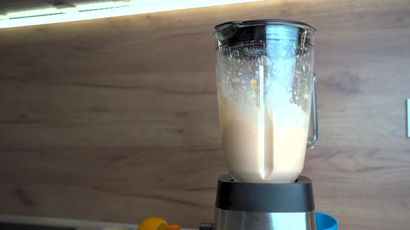 Close Up of Blender with Orange Colored Smoothie