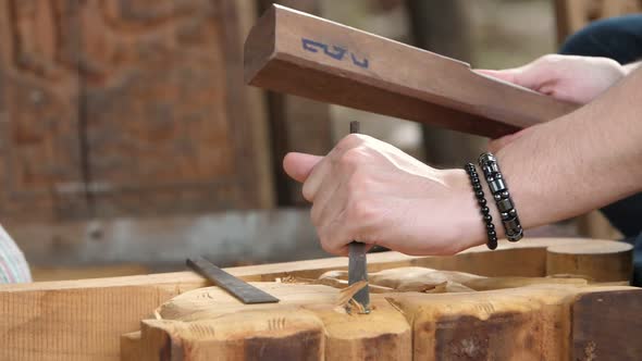 Hands Of Craftsman Carve With A Gouge In The Hands