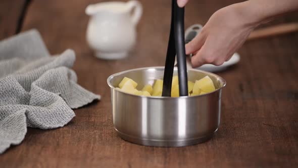 Woman Preparing Mashed Potato in the Kitchen