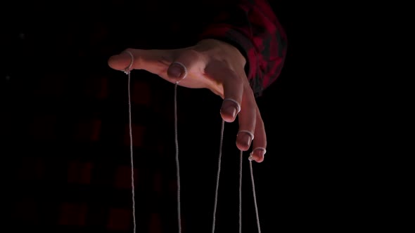 Man Holding a Puppet String