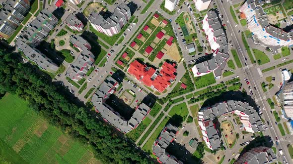 Drone view of city building block. Top down view of new modern block of flats in green area