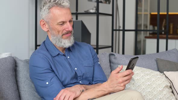 Handsome Mature Man Sending Messages on the Smartphone
