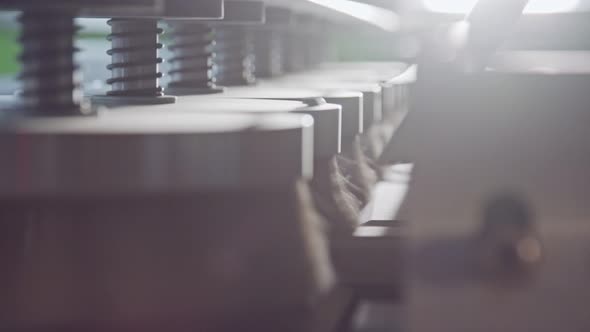 Automated wood polishing machine in a furniture manufacturing facility