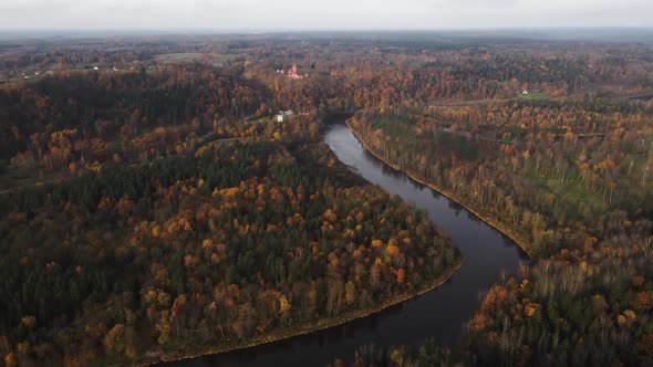 Establishing Shot: Scenic Autumn Flight Over Gauja River Valley with Turaida Castle in Background