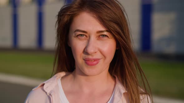 Pretty Redhead Woman Smiles to Camera Standing on Street