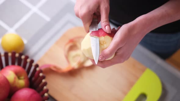 Apple Pie Preparation Series  Woman is Peeling an Apple By Knife