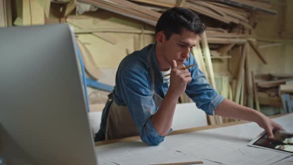 Woodworker Working with Blueprints