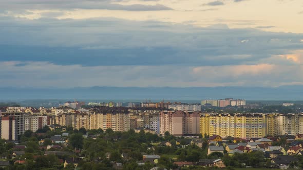 Time Lapse Footage of Fast Moving Evening Clouds on Yellow Sky Over Rural City Area with Distant