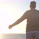 old man looking to the sunset and the sea with opened arms feeling free and happy - freedom - VideoHive Item for Sale
