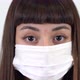 A young girl with protective mask  look at camera. Coronavirus icon. Close up shot. - VideoHive Item for Sale