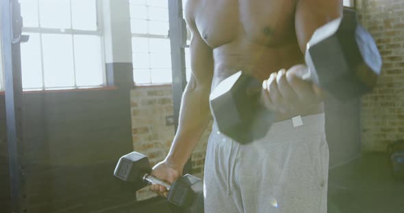 Senior man exercising with dumbbells in the fitness studio 4k