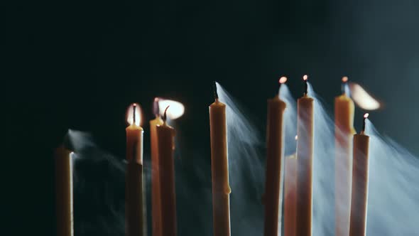 Candles Burn, a Beautiful Orange Flame, Then Go Out From the Wind, Black Background