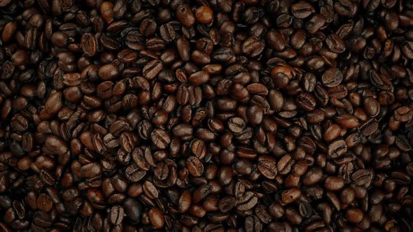 Overhead Shot Of Coffee Beans Pouring Into Pile