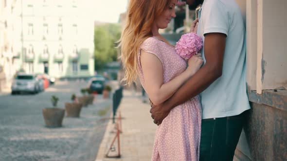 Young Couple in Love Standing and Tenderly Cuddling on Streets of European Cities
