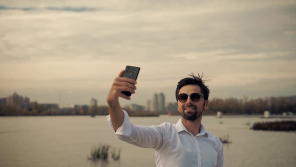Satisfied Man Taking Selfie On Mobile Phone. Businessman In White Shirt Taking Self Photo.