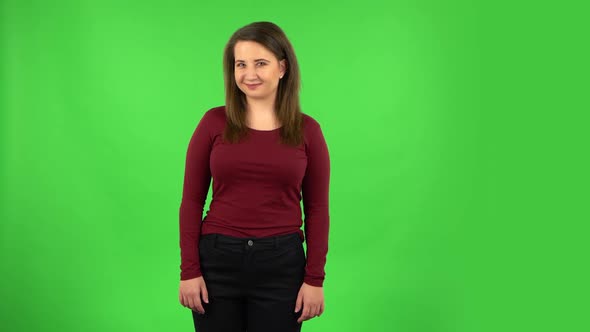 Pretty Girl Smiling While Looking at Camera. Green Screen