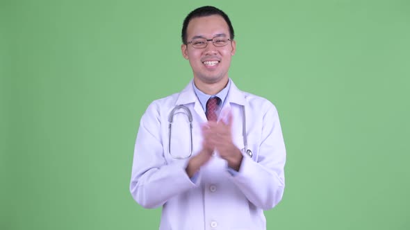 Happy Asian Man Doctor with Eyeglasses Clapping Hands