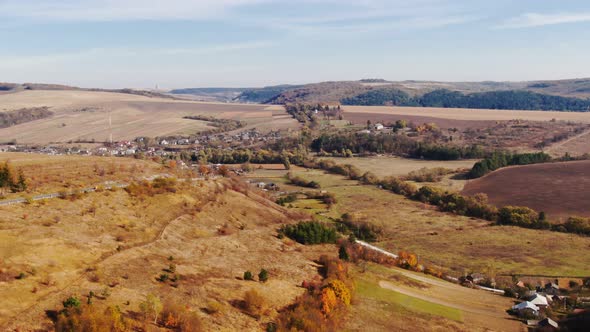 Dolly zoom drone flight over fall village