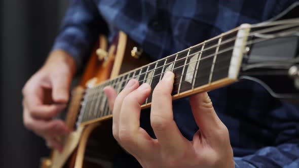 Man hands and fingers playing on electric guitar. Musician playing on electric guitar. Music Concept