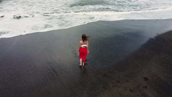 Young Woman Enjoying Vacation on Black Sand Beach