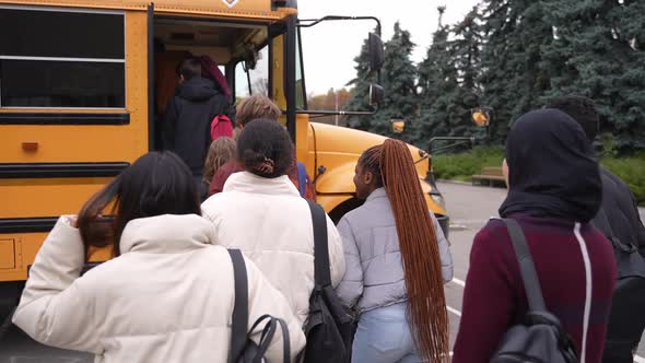 Multinational Teenage Pupils Getting on School Bus