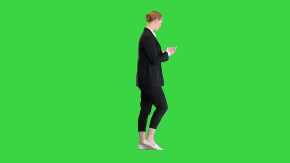 Young Blonde Girl Counting Euros While Walking on a Green Screen Chroma Key