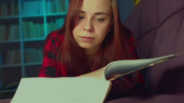 A Beautiful Student Reading a Big Book