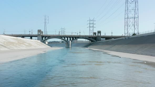 Cinematic Aerial Los Angeles River on Summer Day Bridges Span Shallow River