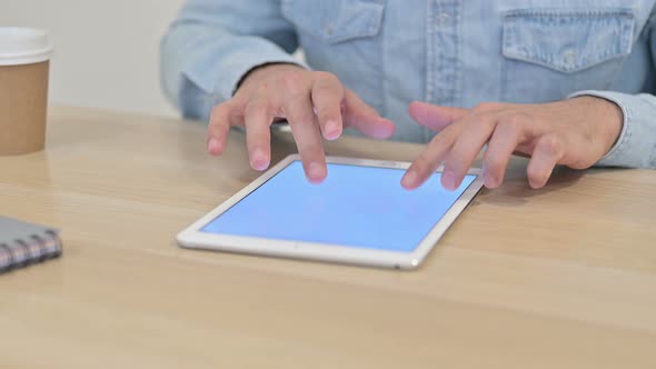 Close Up of Male Hands Working on Tablet 