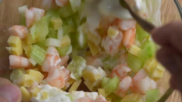 Delicious shrimp salad of cucumber, cheese and onion