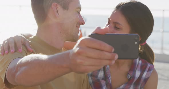 Young adult couple relaxing at the seaside