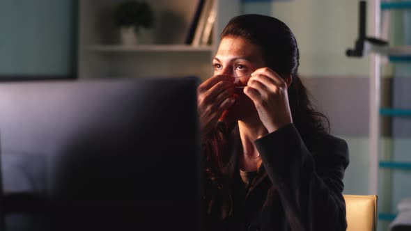 Female Manager Applying Eye Patches During Work