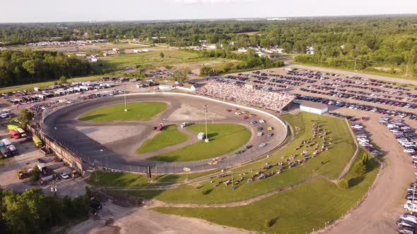 Stock Car Racing On Circle Race Track At Flat Rock Speedway In Monroe County, Michigan. aerial pullb