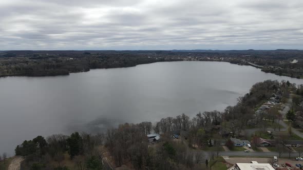 View of Lake Menomonie in Wisconsin on a gray cloudy day. Residential neighborhood on shore.