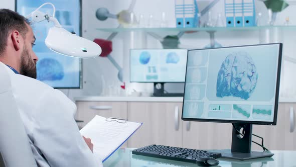 In Modern Research Laboratory Doctor Is Taking Notes in a Clipboard