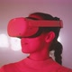 Young woman in red light taking off vr goggles with imagine sign in the background - VideoHive Item for Sale