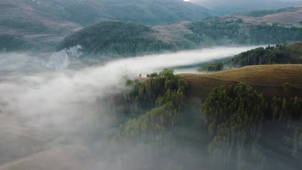 Flying Over Foggy Landscapes In Nature