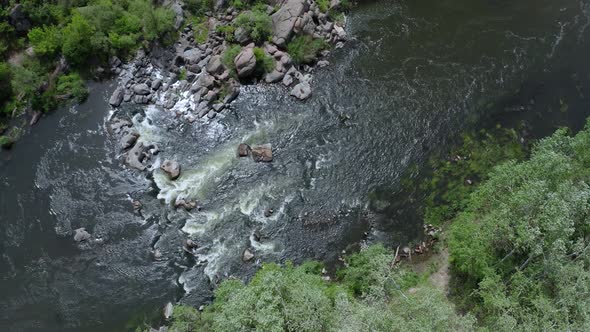 Aerial View of Rocks Across a Section of a Flowing Stream