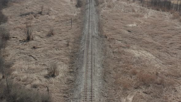 Above railroad track in the meadow 4K drone video