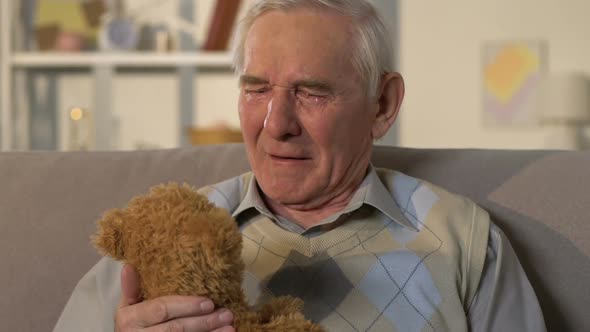 Depressed Crying Widower Holding Bear Toy