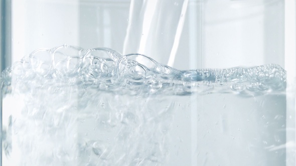 Water Pours Into Glass Closeup