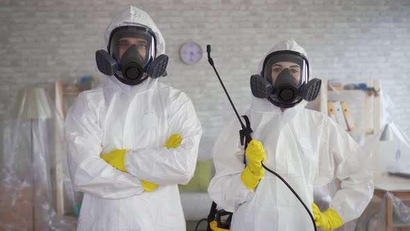 Male and Female Workers in the Cleaning Service or the Exterminator Posing at the Camera