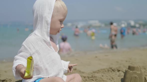 The Funny Little Boy in Summer at the Beach on Vacations