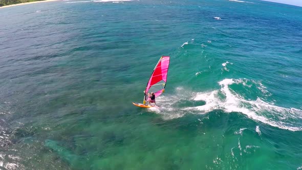 Aerial view of a man windsurfing in Hawaii