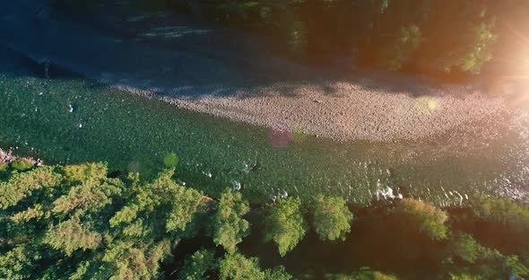 Low Altitude Flight Over Fresh Fast Mountain River with Rocks at Sunny Summer Morning.