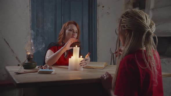 Female Psychic Seeing Future with Candle Lights
