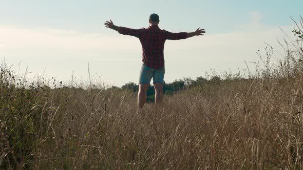 A Lonely Guy In Nature, A Man, Enjoys A Beautiful Landscape, A Happy Man Looks Into The Sky.