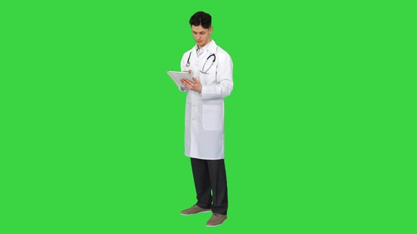 Doctor Holding Digital Tablet Pc and Reading Results on a Green Screen, Chroma Key