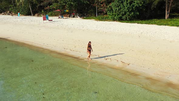 Tourists relaxing on tropical shore beach journey by aqua blue ocean with white sand background of T