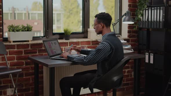 Financial Consultant Analyzing Sales Development on Laptop